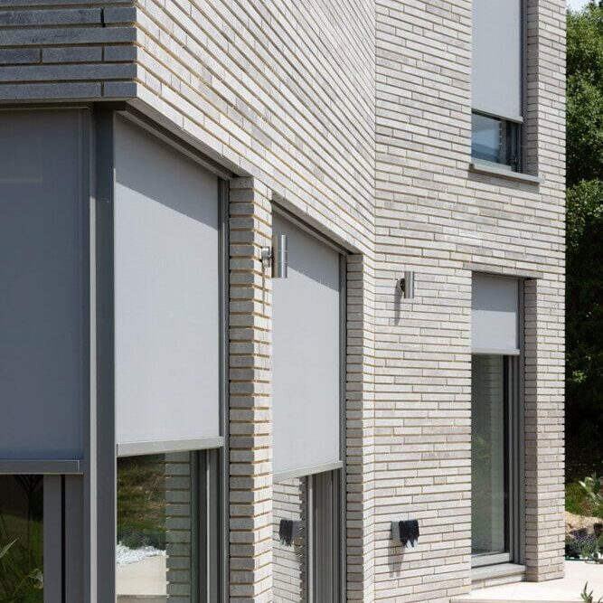 High Bannerdown external blinds exterior blinds fitted to large windows set in brick facade